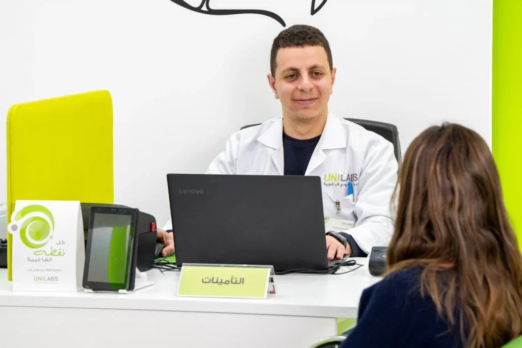 A Unilabs team member speaking with a visitor
