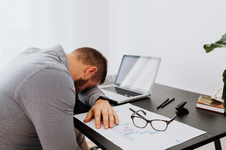 A man resting at his desk